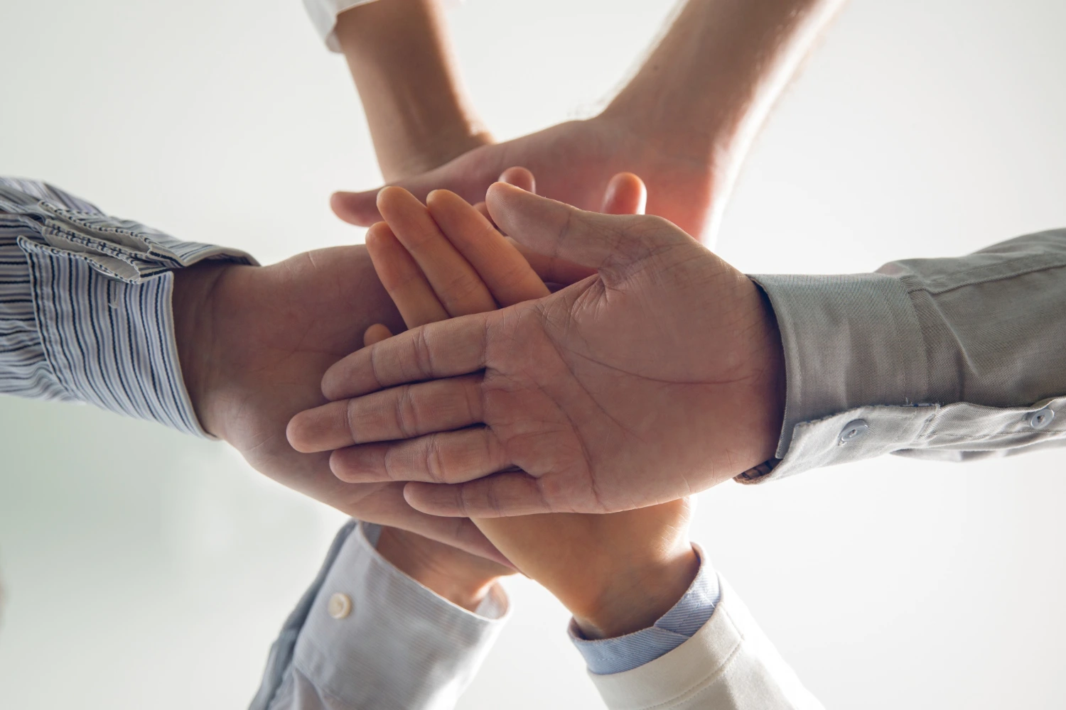 Dịch Vụ Close-Up Of Stacked Hands Of Business Team